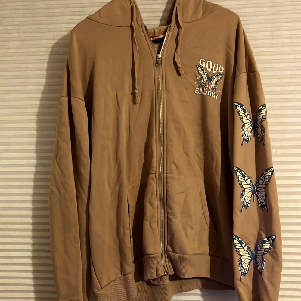 Protect your good energy tan and blue zip up butterflies on sleeve